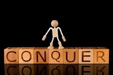 wood-cube-block-word-conquer-wooden-stick-figure-standing-black-background-conquering-fear-suc...jpg